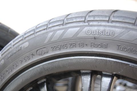 2002 BMW M3 - Close-up of a tire showing its size and DOT code, indicating it was manufactured in the 47th week of 2004.