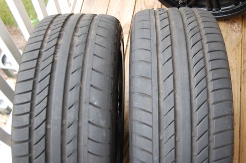 2002 BMW M3 - Close-up view of two car tires, showing their tread patterns and sidewalls.