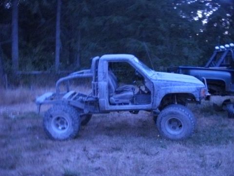 1985 Toyota Pickup/SR5 - Modified 1985 Toyota Pickup/SR5 with roll cage and removed doors, parked outdoors.