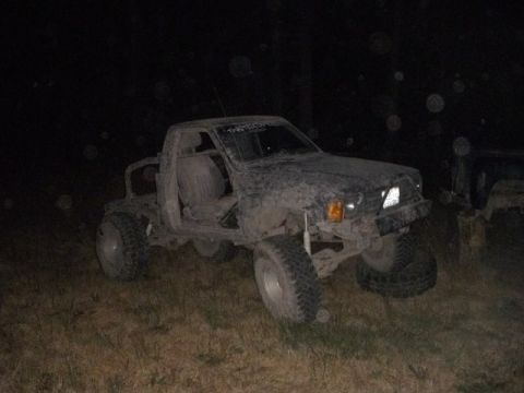 1985 Toyota Pickup/SR5 - This heavily modified truck is covered in mud and appears to be off-road.