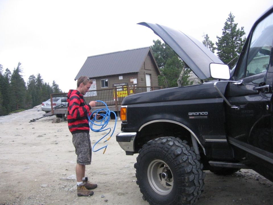 Black 1989 Ford Bronco with hood open, side view