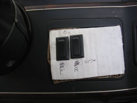 1989 Ford Bronco - Aftermarket auxiliary switches with handwritten labels on a vehicle's dashboard.