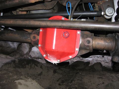 1989 Ford Bronco - Close-up view of a red differential cover on a vehicle's undercarriage.