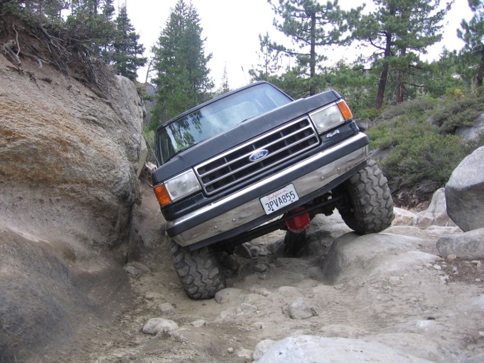 Ford F-series truck navigating a rocky trail, front 3/4 view. License plate 3PVA855