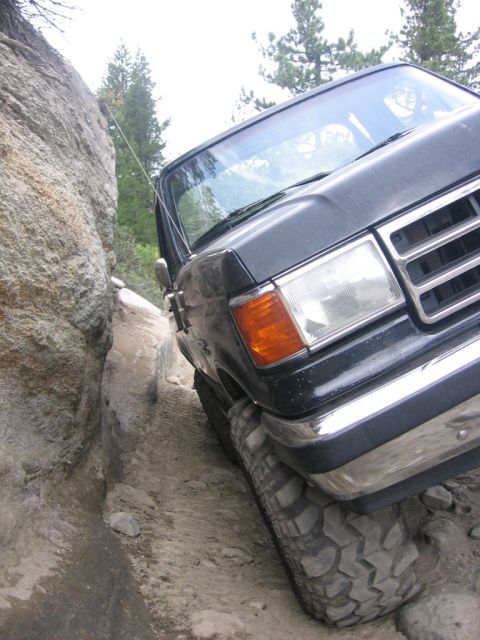 1989 Ford Bronco - This Ford truck is carefully maneuvering through a tight spot on a off-road trail.