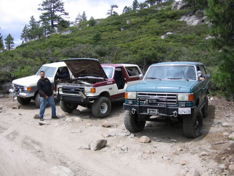 Teal 1987 Ford Bronco front view with winch and aftermarket bumper