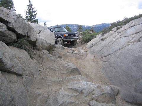 1989 Ford Bronco - This 1989 Ford Bronco is tackling a challenging rocky trail in a mountainous area.