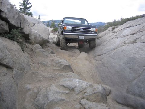 1989 Ford Bronco - This 1987 Ford F-150 navigates a challenging rocky trail, demonstrating its off-road capabilities.