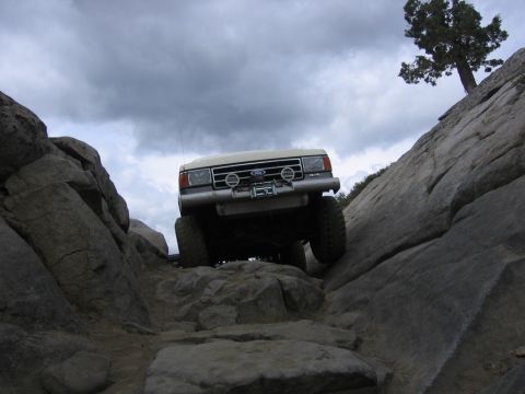 1989 Ford Bronco - This 1989 Ford Bronco is shown tackling a challenging rocky terrain, demonstrating its off-road capabilities.