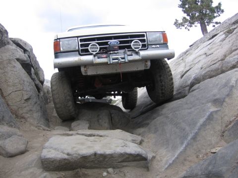 1989 Ford Bronco - This 4x4 vehicle navigates a challenging rocky terrain, demonstrating its off-road capabilities.