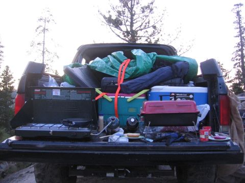 1989 Ford Bronco - Camping gear packed in the bed of a pickup truck, ready for an outdoor trip.