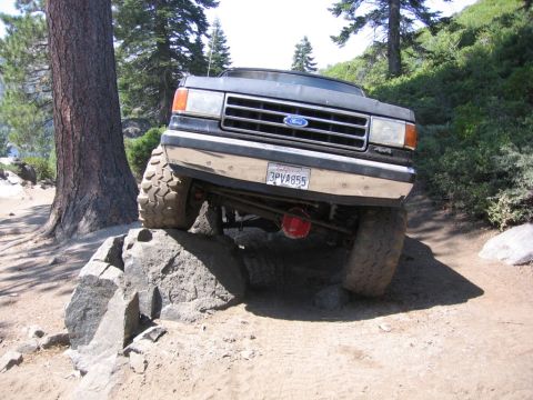 1989 Ford Bronco - This 1989 Ford Bronco navigates a rocky trail with its front wheels high off the ground.