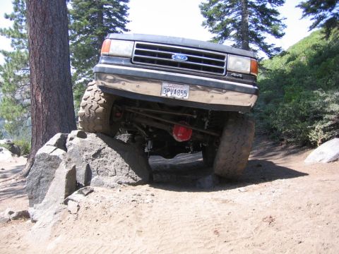1989 Ford Bronco - 1989 Ford Bronco navigating rocky terrain off-road.