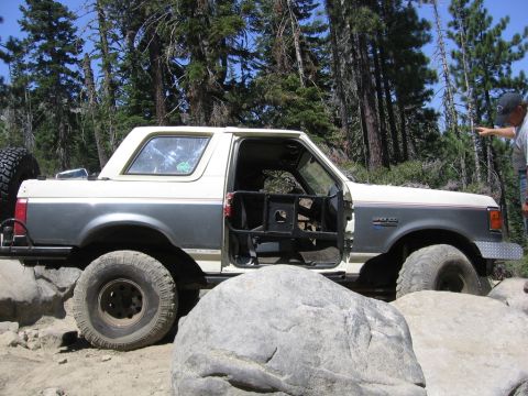 1989 Ford Bronco - This modified 1989 Ford Bronco navigates a challenging rocky trail, its off-road capabilities.
