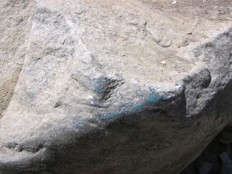 1989 Ford Bronco - A large boulder is marked with spray paint in various colors.