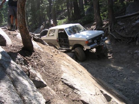 1989 Ford Bronco - This 1989 Ford Bronco is tackling a challenging rocky trail in the woods.