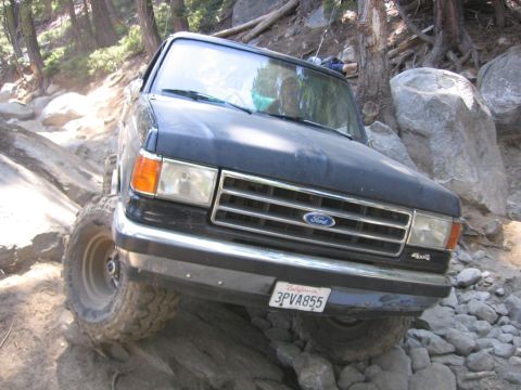 1989 Ford Bronco - This Ford Bronco is navigating a challenging, rocky off-road trail.