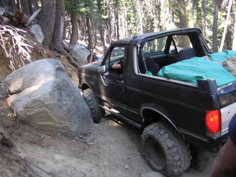 1989 Ford Bronco - This 1989 Ford Bronco is shown navigating a challenging rocky trail, demonstrating its off-road capabilities.