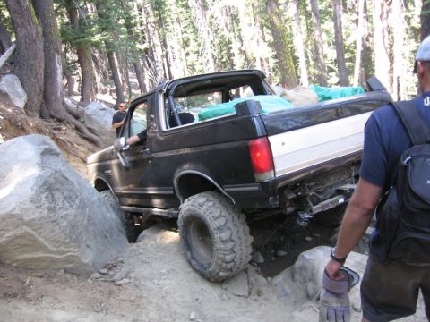 1989 Ford Bronco - This 1989 Ford Bronco is tackling a challenging rocky trail in a wooded area.