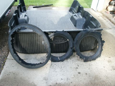 2000 Ford F-250 - Three damaged tires are visible in the bed of a pickup truck.