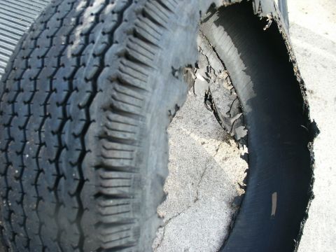 2000 Ford F-250 - This tire has sustained significant damage to its sidewall, revealing its internal construction.