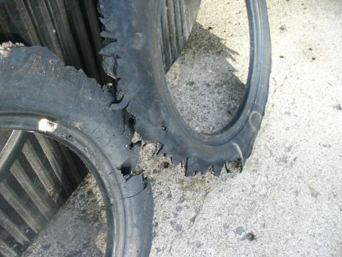 2000 Ford F-250 - The sidewalls of two tires are heavily damaged, showing significant tearing and wear.