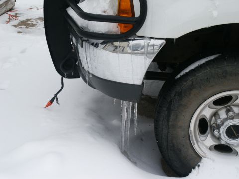 2000 Ford F-250 - Front view of a 2000 Ford F-250 in the snow, showing icicles hanging from the bumper and grille guard.