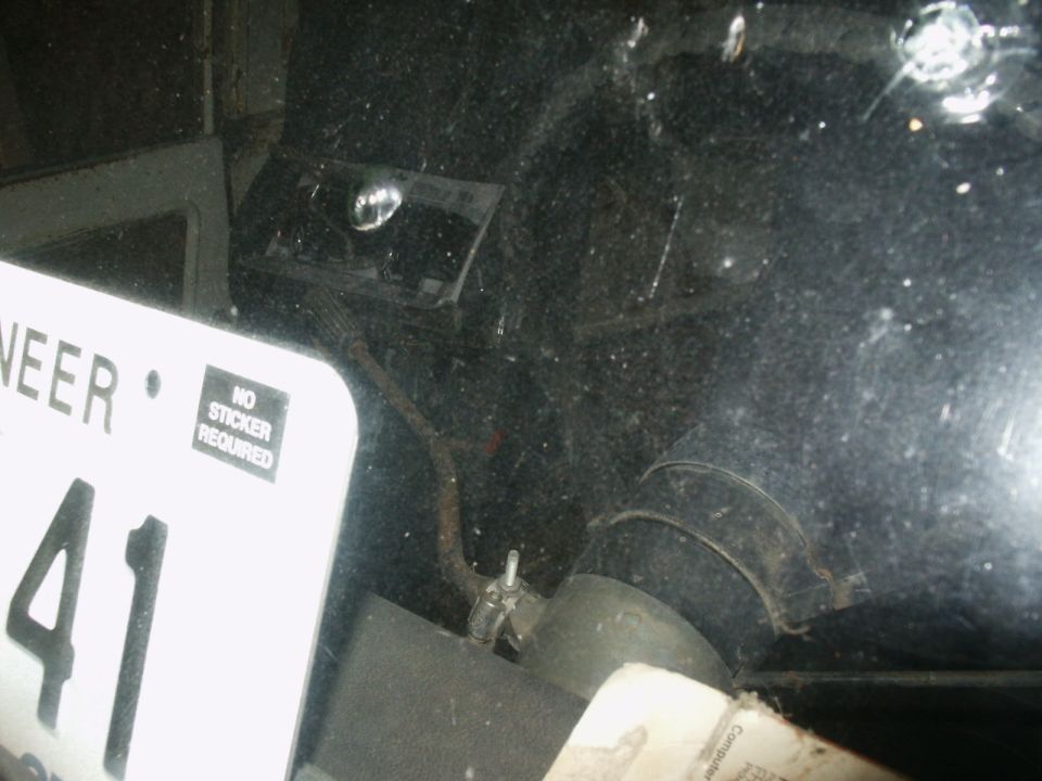 License plate reading 'NEER 41' with 'NO STICKER REQUIRED' and part of a dark interior