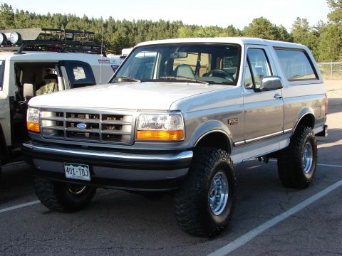 1995 Ford Bronco - Lifted 1995 Ford Bronco with aftermarket wheels and tires, parked outdoors.