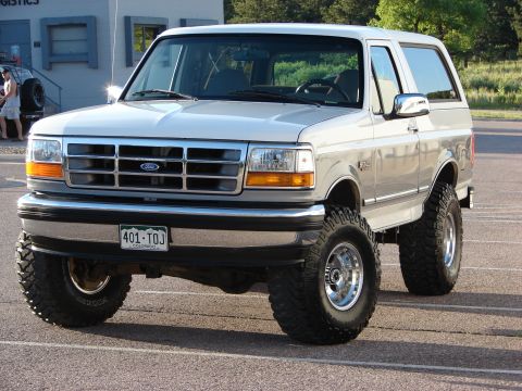 1995 Ford Bronco - This lifted Ford Bronco has a chrome grille and large off-road tires.