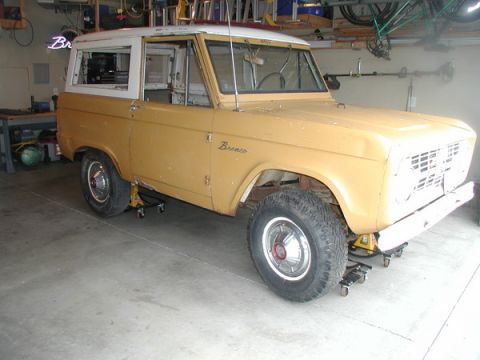 1966 Ford Bronco - This 1966 Ford Bronco is on jack stands in a garage, showing its body style and a removed front grille.