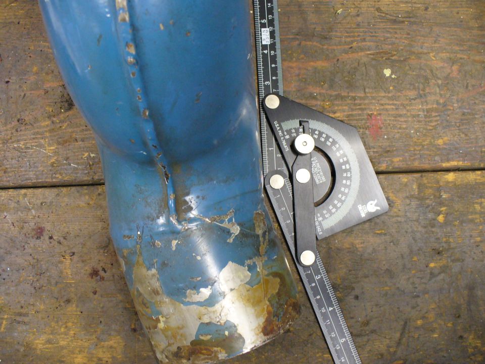 Blue exhaust pipe with rust and peeling paint, measured by a protractor and ruler