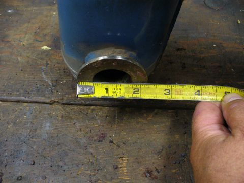 1978 Ford Bronco - Measuring the diameter of a blue exhaust pipe with a yellow tape measure.