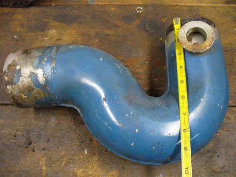 1978 Ford Bronco - A blue exhaust pipe is shown with a measuring tape, indicating its dimensions. The part appears to be used.