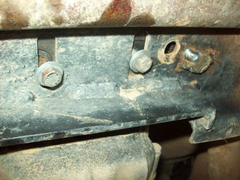 1985 Ford Bronco - This image shows a close-up view of the vehicle's undercarriage, focusing on the frame and mounting hardware.