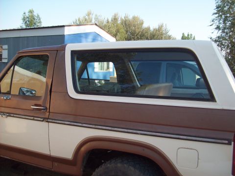1985 Ford Bronco - This 1985 Ford Bronco is shown from the side, a two-tone brown and white paint scheme.