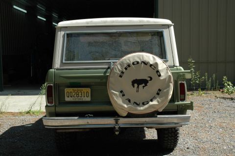 1973 Ford Bronco - This green SUV features a spare tire cover with 'BRONCO RANGER' text and a horse graphic.