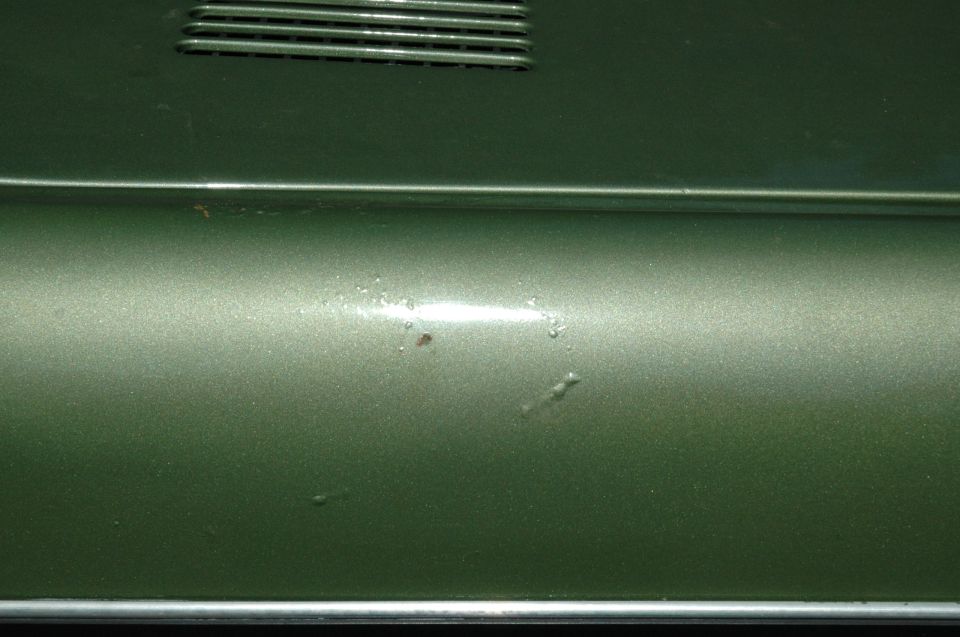 Green metallic 1973 Ford Bronco side panel with vent detail