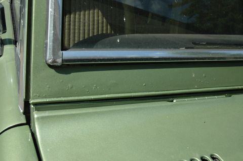 1973 Ford Bronco - Close-up of the side panel and window trim on a 1973 Ford Bronco.