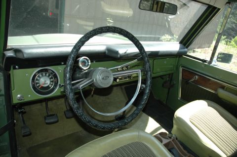 1973 Ford Bronco - Interior view of a 1973 Ford Bronco, its distinctive green dashboard and patterned seat inserts.