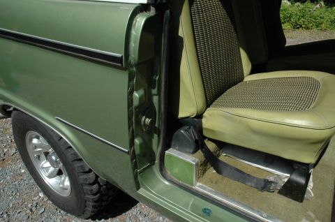 1973 Ford Bronco - The interior of a 1973 Ford Bronco shows off its distinctive houndstooth seat fabric and green exterior paint.