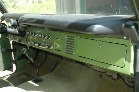 1973 Ford Bronco - The interior of a classic SUV shows the dashboard with various controls and a vintage radio.