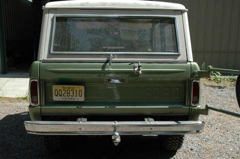 1973 Ford Bronco - The rear of a classic Ford Bronco shows its tailgate, bumper, and license plate.