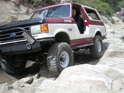 1991 Ford Bronco - This modified Ford Bronco navigates a challenging rocky terrain, its off-road capabilities.