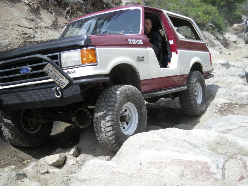 Ford Bronco on rocky trail, driver visible. License plate 2ZSX148