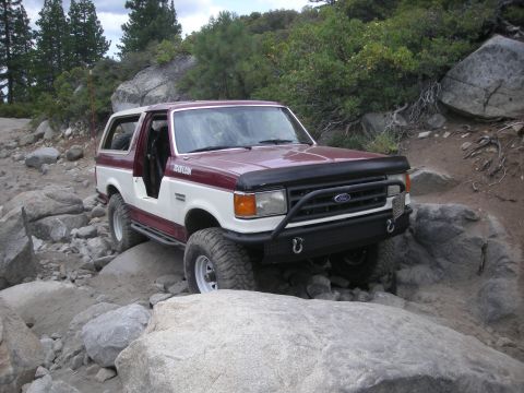 1991 Ford Bronco - This 1991 Ford Bronco is shown tackling a challenging off-road course with large boulders.