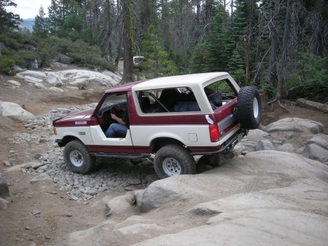 1991 Ford Bronco - This two-tone red and white 1991 Ford Bronco tackles a challenging rocky trail.