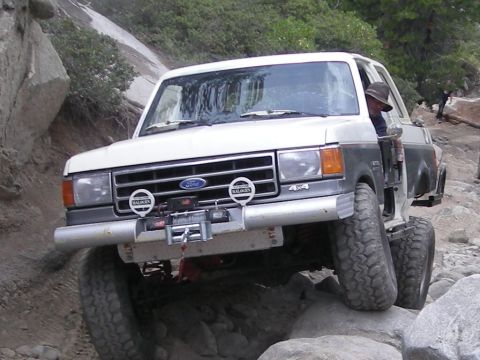 1991 Ford Bronco - This 1991 Ford Bronco is tackling a challenging off-road trail with large rocks.