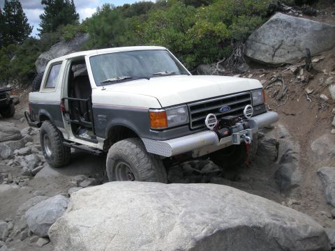 1991 Ford Bronco - This 1991 Ford Bronco is tackling a challenging off-road course with large rocks.