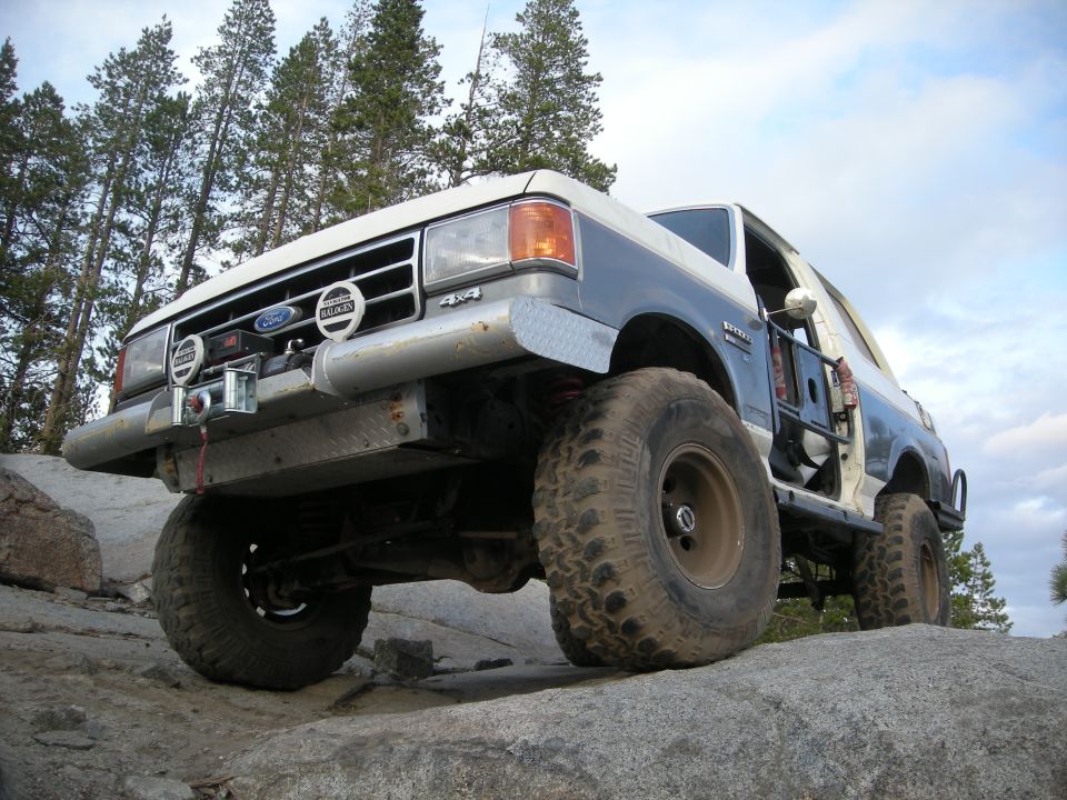 1991 Ford Bronco with off-road modifications on rocky terrain